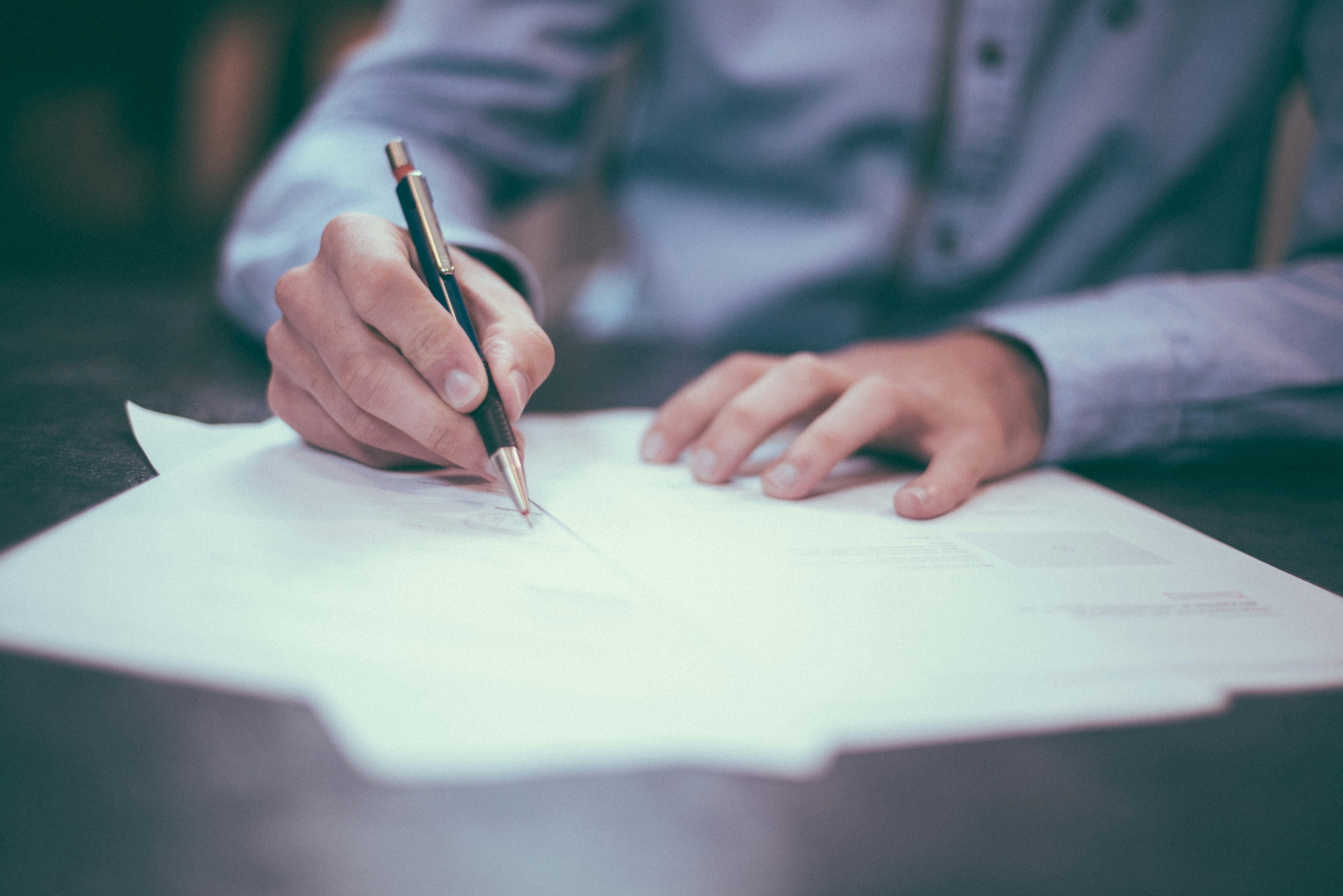 business man writing on paper